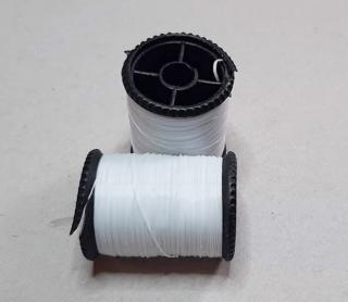 Rugalmas fehér damil, kis orsó 0,4 mm. Gyöngyfűző gumi.  290 Ft / orsó. /10 méte ()